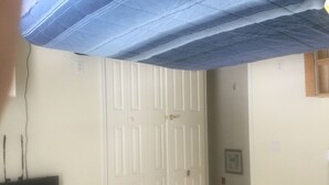 A room with a white door, a small window, and a wall-mounted electrical outlet. - Walk to the ocean and Boardwalk (Seaside Park)