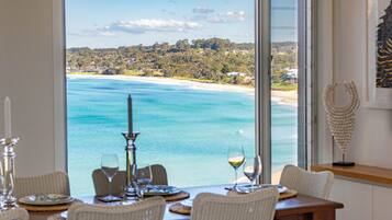 Enjoy a meal with a view of the coastal landscape from this dining area.