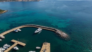 A marina with boats docked, a pier, and a mountainous backdrop. - Nice apartment for 4 guests with WIFI, pool, TV, terrace and pets allowed (Regia Dogana)