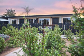 A mobile home with a fenced yard, a number '323' sign, and a view of the sky. - Kauai-Inspired California Beach Retreat, Unit 3 (Oceanside)