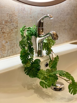 A bathroom sink with a modern faucet and a decorative plant. - Hotel Venus Garden - Adults Only (Nagoya)