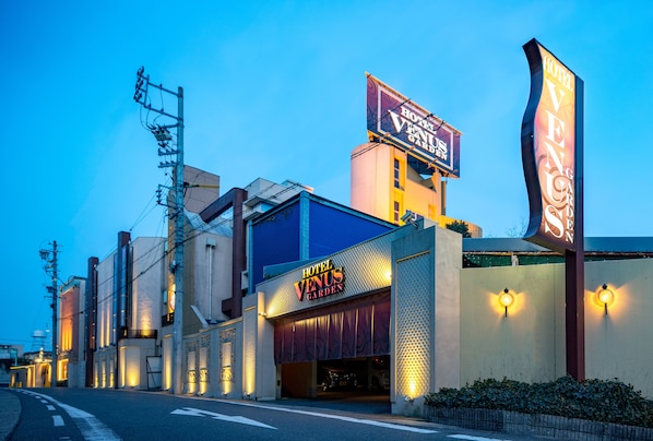 A hotel with a prominent sign reading "Hotel Venus Garden" and a large banner advertising "Hotel Venus Garden." - Hotel Venus Garden - Adults Only (Nagoya)