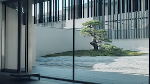 A modern interior with a view of a landscaped area featuring a bonsai tree and a small pond. - MUNI KYOTO (Kyoto)
