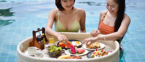 Alberca al aire libre, sombrillas en la alberca y camastros