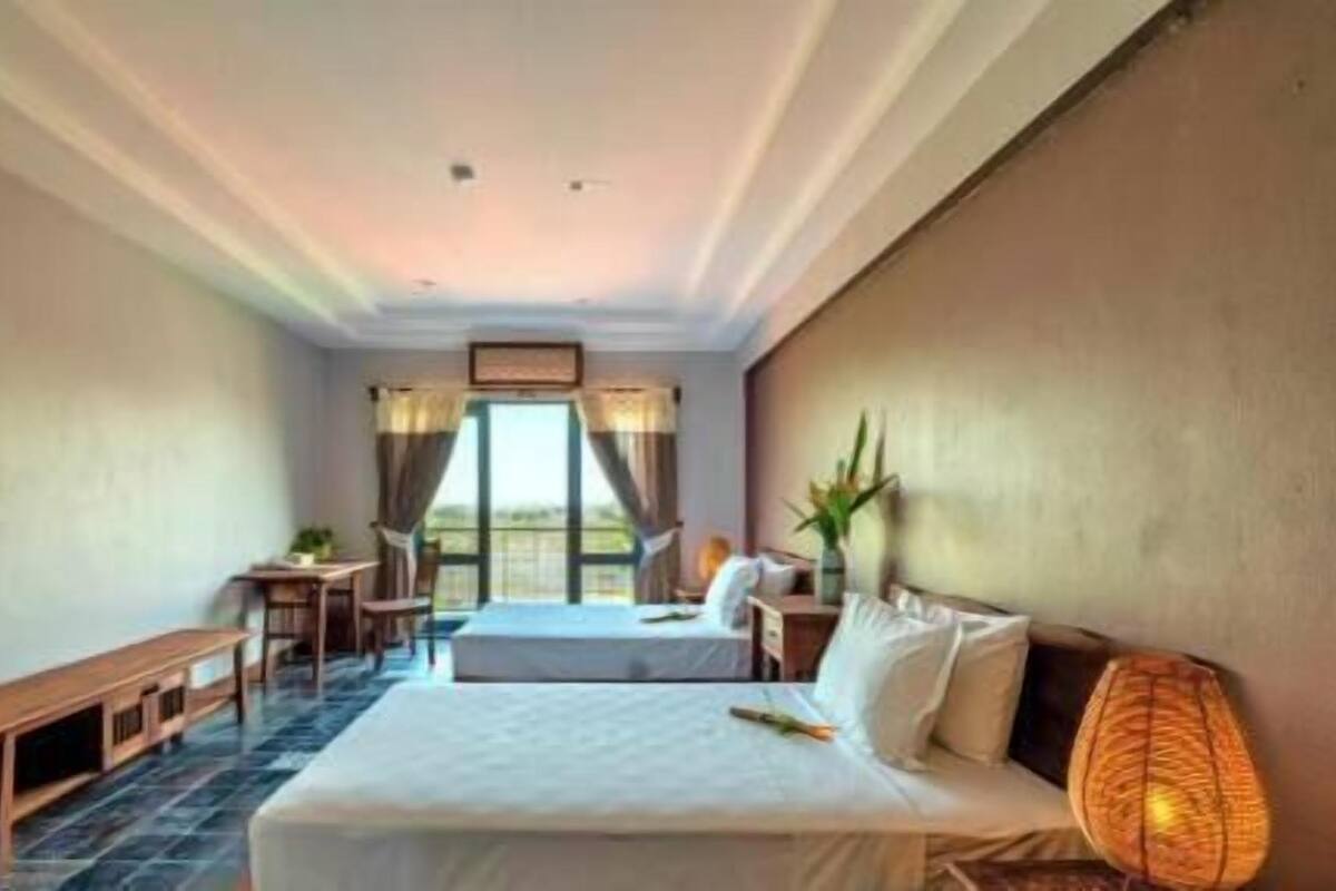 A bedroom with a bed, a desk, a chair, and a bench.
