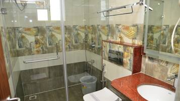Separate bathtub and shower, towels