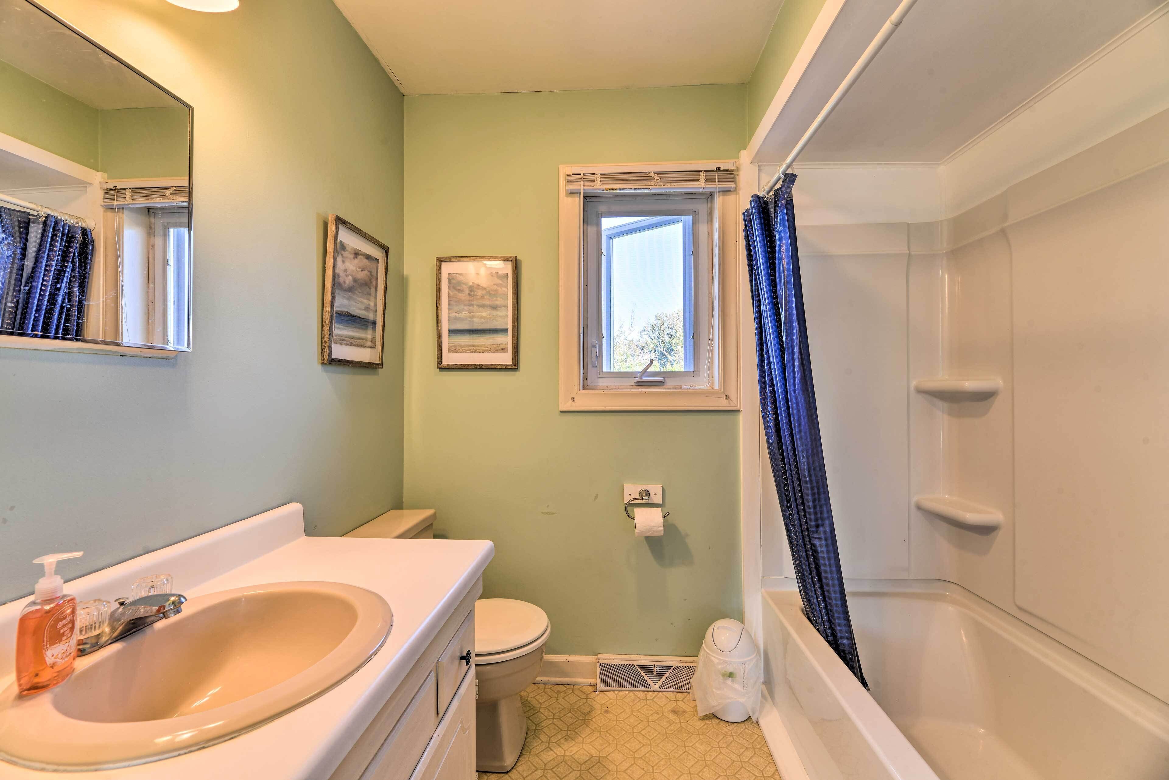 A bathroom with a sink, toilet, and bathtub.