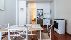 A compact kitchen with a microwave, oven, and sink.