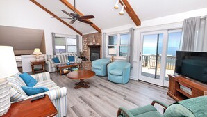 A living room with a sofa, armchairs, a coffee table, a fireplace, and a TV. - OCEANFRONT, Ocean views, screened porch, NP15-1, Pelican Dunes (Duck)