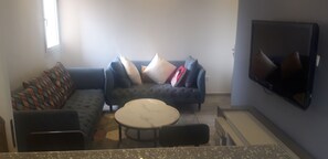 Premium Double Room | Living area | Flat-screen TV