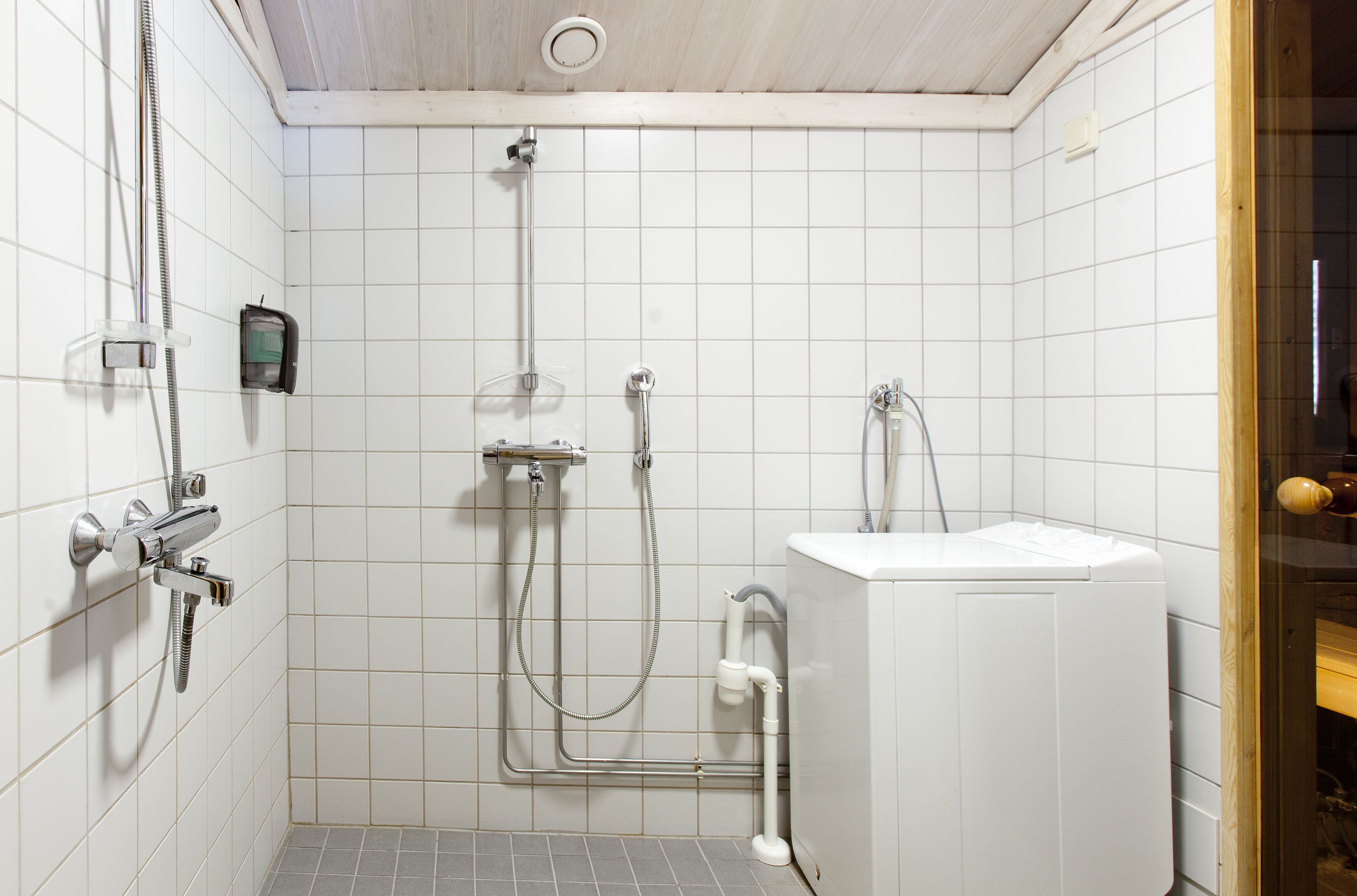 Een badkamer met een douche, toilet en wastafel.