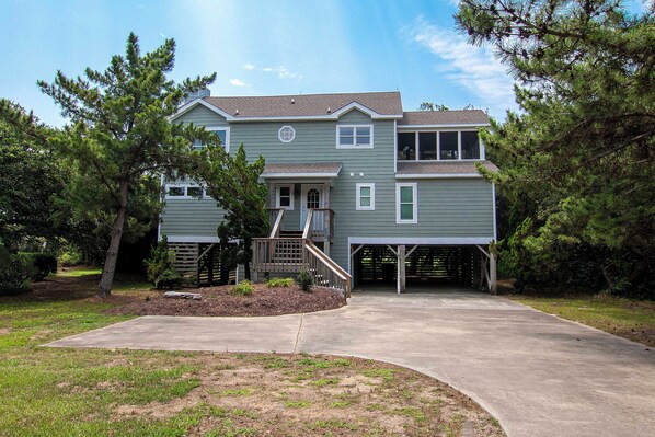 Stroll up to this charming two-story home, featuring a welcoming front porch and beautifully landscaped surroundings.