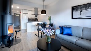 Una sala moderna con chimenea, un comedor y una cocina.