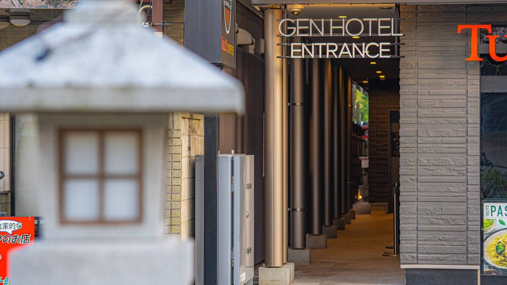 La entrada de un hotel con un letrero que dice "GEN HOTEL ENTRANCE".