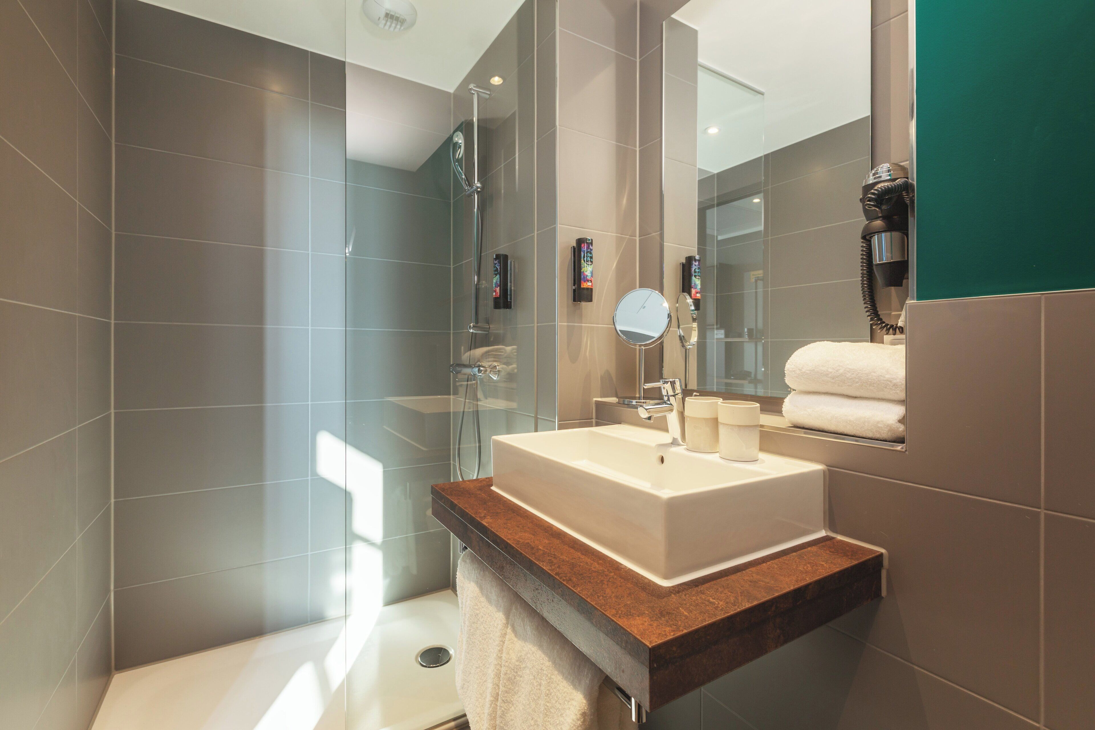 shower, hair dryer, towels, soap