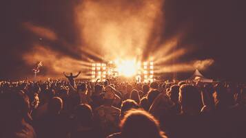 A concert with a large crowd and stage lighting.