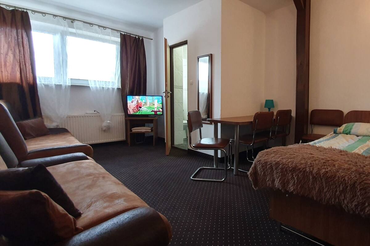 Quadruple Room | Living area | Flat-screen TV