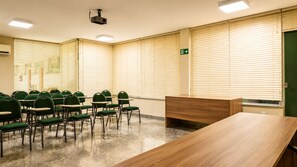 A conference room with a long table and multiple chairs.