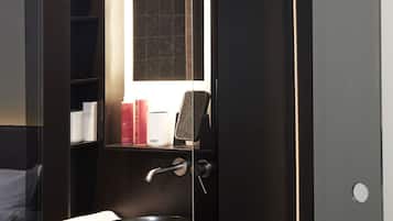 A modern bathroom with a built-in sink, a towel, and a mirror.