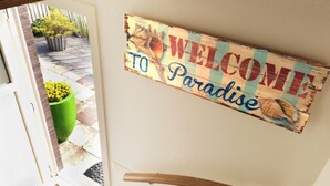 Una porta amb un cartell que diu 'Welcome to Paradise'.