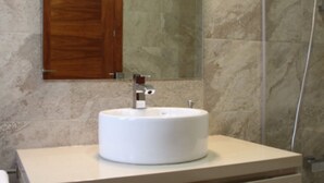 A bathroom with a round white sink, a wooden cabinet, and a mirror. - Rural house viaverde del Tajuña (Perales de Tajuña)