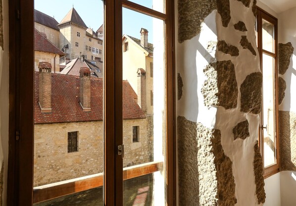 A room with a view of traditional buildings through a window.