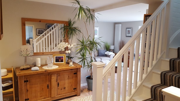 A staircase with white railings leading to a second floor. - B&B By The Sea (Lymington)