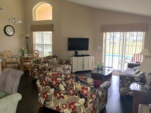 Relax in style with a comfortable sofa, flat-screen TV, and dining area.