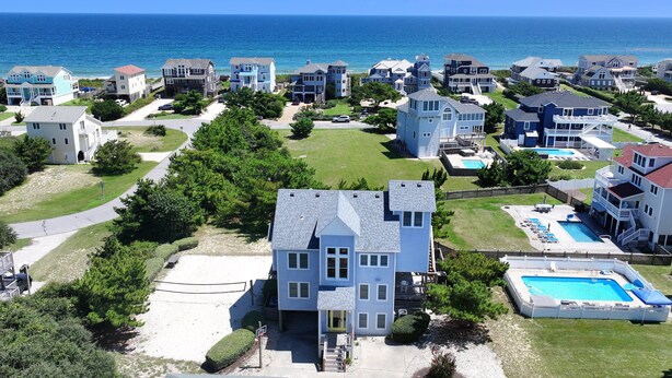 A coastal residential area with multiple houses, a swimming pool, and a clear view of the ocean. - Oceanside, Private Pool, Close to Beach, Hot Tub! SP2, Blew Bayou (Duck)