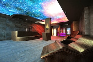 Een moderne spa met een sterrenhemelplafond, een receptie en comfortabele loungers.