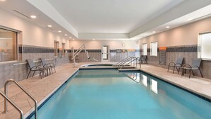 An indoor swimming pool with clear water, surrounded by lounge chairs and a tiled floor. - La Quinta Inn & Ste by Wyndham Wisconsin Dells- Lake Delton (Wisconsin Dells)