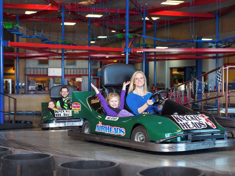 A go-kart ride with a child and an adult.