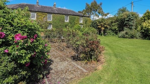 A house with a garden, a lawn, and a clear blue sky. - Cairbre House (Dungarvan)