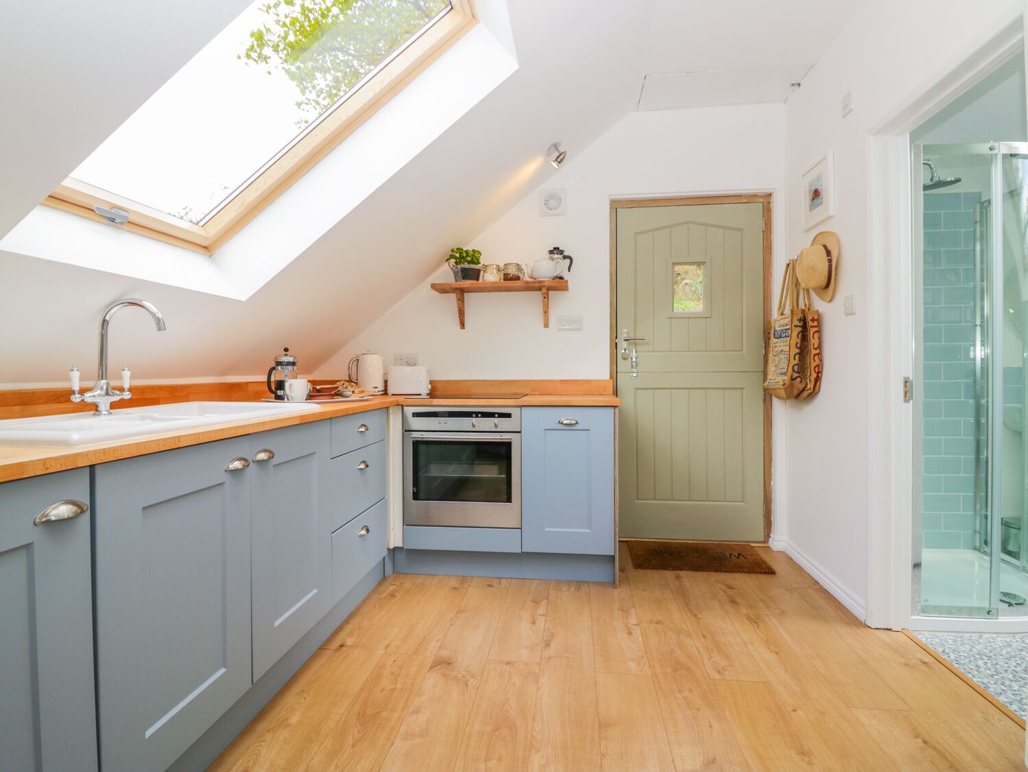 A compact kitchen with a skylight, a built-in oven, and a small countertop.