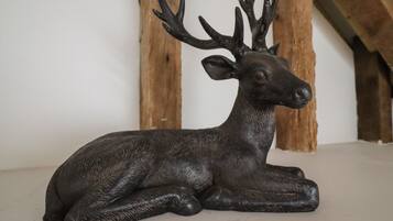 A bronze deer sculpture on a shelf.