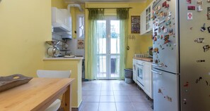 Apartment, 1 Bedroom, Balcony | Private kitchen | Fridge, oven, stovetop, cookware/dishes/utensils - JOIVY Cozy Flat for 4 w/ Patio, Nearby Navigli (Milan)