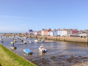 A harbor with boats docked along the quay, surrounded by colorful buildings. - Bari (Aberaeron)
