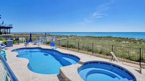A swimming pool with lounge chairs and a view of the beach. -  Siren's Song--Gorgeous Oceanfront House with Pool and Spa! (Kure Beach)