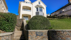 A two-story building with a stone facade and a sign reading "Chichester Court". - 6 Chichester Court (Kingsbridge)