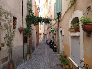 Stroll through historic streets lined with traditional buildings, potted plants, and bicycles.