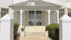 A white building with a sign reading "PROSPECT HOUSE" above the entrance.