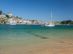 Enjoy waterfront views of the marina and sailboats docked at the shore.