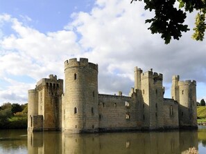 A historic castle with multiple towers and a moat.