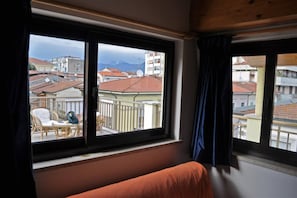 Enjoy a peaceful view of the surrounding residential area and distant mountain from this room's large window.
