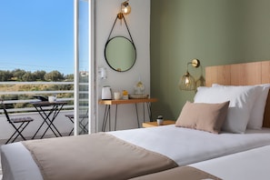 A bedroom with a bed, bedside table, lamp, and a view of the outdoors. - Charm Hotel Hersonissos (Hersonissos)