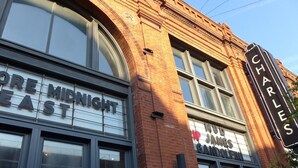 A building with a sign reading "Charles" and another sign for "Midnight East". - Charm in the City (Baltimore)