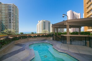 Enjoy ocean views from the rooftop pool surrounded by a stone deck and shaded pergola.