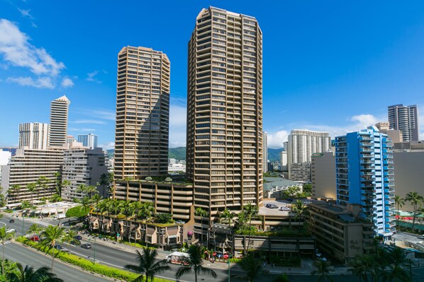 Standing tall amidst a vibrant urban landscape, this hotel boasts a striking curved facade.