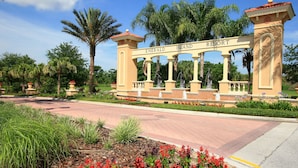 A gated entrance with the words "Emerald Island Resort" on a sign. - Emerald Blossom by VillaDirect (Kissimmee)