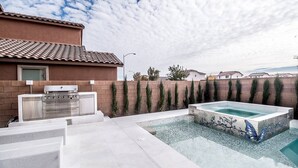 A backyard with a swimming pool, a barbecue grill, and a brick wall. - BUTTERFLY Lounge w/2 Masters - 12 min f/the Strip (Las Vegas)